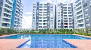 a swimming pool in front of some tall buildings at Urban Stays-Two bedroom Near JKIA Airport in Nairobi