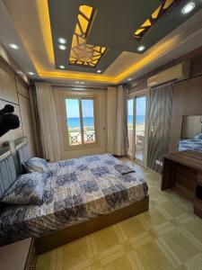 a bedroom with a bed with a view of the ocean at La Sirena Villa for Families only in Ain Sokhna +19 photos