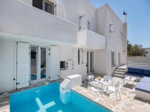 a villa with a swimming pool and a house at Casa De Tamara Paros in Kampos Paros
