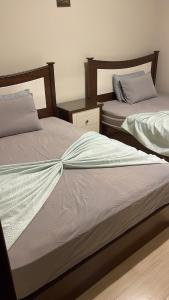 two beds sitting next to each other in a room at Ground peaceful chalet 3 bedroom with 6 king bed & 2 bathrooms &private garden marvelous land escape Murano resort Ain sokhna in Ain Sokhna