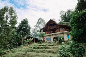 a house on the side of a hill at Bukit Lawang - Batu Kapal Rimba House in Bukit Lawang