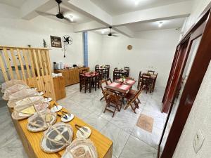 a living room with a table and chairs and a dining room at Morada da Praia Pousada in Jericoacoara
