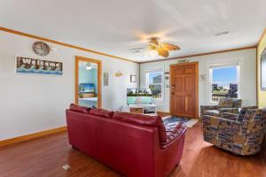 a living room with a red couch and two chairs at 6153 - Seascape in Nags Head