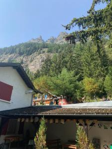 a view of a house with a mountain in the background at Relais de Van d'en Haut in Salvan