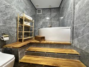 a bathroom with a bath tub and a toilet at MorAgop Suites in Istanbul +37 photos