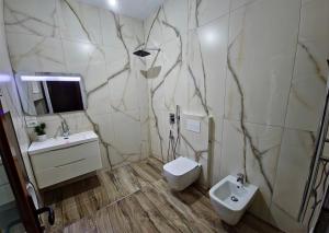 a bathroom with a toilet and a sink at Guri Imperium in Krujë +27 photos