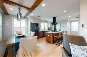 a kitchen and living room with a table and chairs at Happy Ours in Mexico Beach