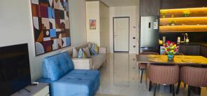 a living room with a blue couch and a table at SEA BREEZE Baku-FH in Baku
