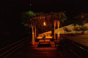 a night view of a porch with a table and chairs at Recanto do villa 2 in Trancoso