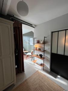 a living room with a door open to a dining room at Veules-les-Roses Studio in Veules-les-Roses