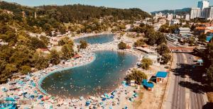 an aerial view of a beach with people in the water at CityOasis Tuzla in Tuzla