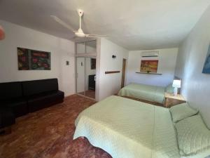 a living room with two beds and a couch at Dani's Guesthouse in Las Galeras