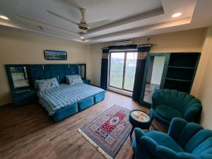 a bedroom with a bed and a living room at Private 1 BHK Suite - Islamabad, Bahria Town in Rawalpindi