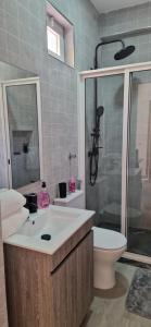 a bathroom with a sink and a toilet and a shower at Ines Studio T0 - Inforsal in Espargos