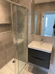a bathroom with a sink and a shower at Cosy apartment near Edinburgh city centre in Edinburgh
