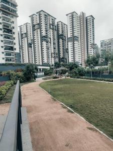 a park in a city with tall buildings at The Zenith Stay in Hyderabad