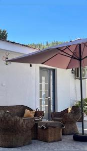 a group of wicker chairs and an umbrella on a patio at royal room in Ulcinj