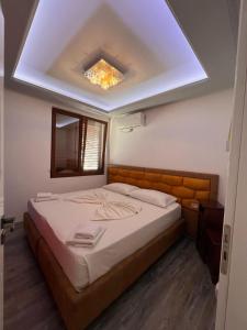 a bedroom with a large bed with a skylight at Vila Behar - Penthouse Apartment with seaview in Sarandë