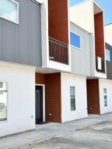 a facade of a building with a door at The Festival Retreat KING Bd Cajun Luxury Book Now in Lafayette