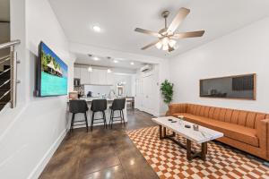 a living room with a couch and a table at The Festival Retreat KING Bd Cajun Luxury Book Now in Lafayette