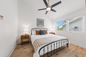 a bedroom with a bed and a ceiling fan at The Festival Retreat KING Bd Cajun Luxury Book Now in Lafayette