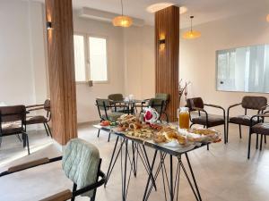 a table with bread and pastries on it in a room at Titi's Villa in Durrës +28 photos