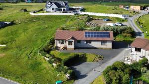 an aerial view of a house with a solar roof at Solheim Self Catering in Whiteness