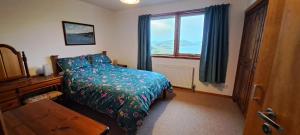 a bedroom with a bed and a window at Solheim Self Catering in Whiteness