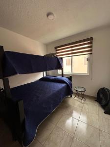 a bedroom with two bunk beds and a window at Casa con Alberca en condominio in Yautepec de Zaragoza +46 photos