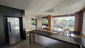 a kitchen and dining room with a refrigerator and a table at Apartamento Fantástico COP30 - 1o Aluguel - Novo! in Belém