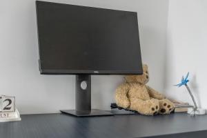 a teddy bear sitting in front of a computer monitor at Luxury 3BR with 2bath Near Westfield Stratford in London