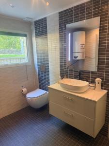 a bathroom with a sink and a toilet and a mirror at Guest house in Lyckeby in Karlskrona +32 photos