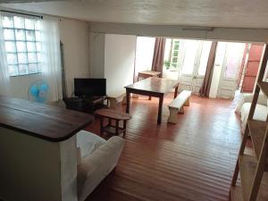 a living room with a table and a couch at les 3 écrevisses in Antananarivo