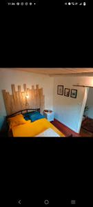 a bedroom with a large bed with a wooden headboard at les 3 écrevisses in Antananarivo