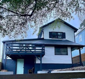 a white house with a porch with a balcony at 2 Mins Walk To Benz Stadiumarcade Game Sleeps 11 in Atlanta