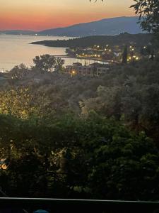 a view of a city and the ocean at sunset at Margianou Seaview Apartments 3 & 4 in Kálamos