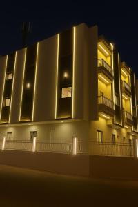 a building with lights on the side of it at night at شقة حي الوزارات in Riyadh