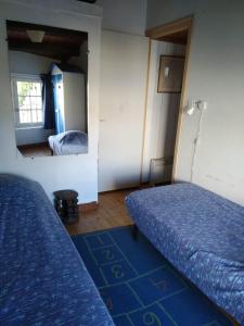 a room with two beds and a mirror at Maison au centre du village in Les Portes