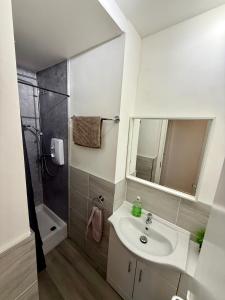 a bathroom with a sink and a shower at Stephen's Street Apartment, Inverness City Centre in Inverness
