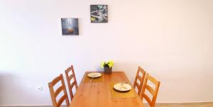 a dining room table with four chairs and a table at Thalassa View c3 in Khalkoútsion +4 photos