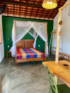 a bedroom with a bed with a canopy at Loft 1 - Casa Aratu Guaiú Barra de Mamanguape in Rio Tinto