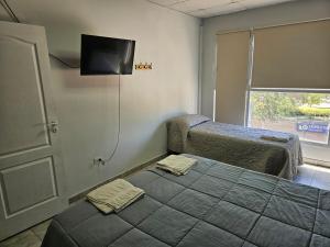 a bedroom with two beds and a flat screen tv at dto kumelen in Plottier