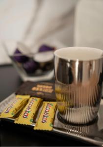 a table with a coffee cup and some books at Chambre avec Salle de Bain Privative in Tarbes +33 photos