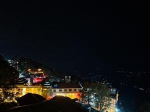 a view of a city at night with lights at 4 Bedroom Penthouse - ELEV8 in Murree