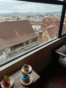 two plates sitting on a table in front of a window at Le Réverbère in Antananarivo