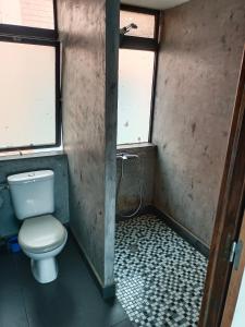 a bathroom with a toilet and a window at Le Réverbère in Antananarivo +10 photos