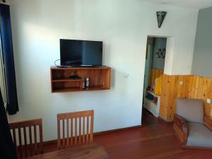 a living room with a flat screen tv on a wall at Le Réverbère in Antananarivo