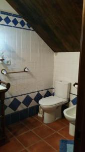 a bathroom with a toilet and a sink at Casa Golmar 20 in Cedeira +42 photos