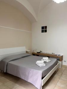 um quarto com uma cama com duas toalhas em L'Albero della Vita em Catânia