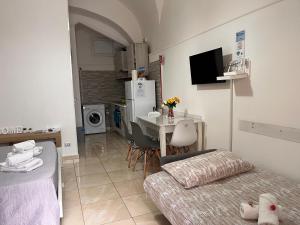 uma pequena sala de estar com uma mesa e uma cozinha em L'Albero della Vita em Catânia